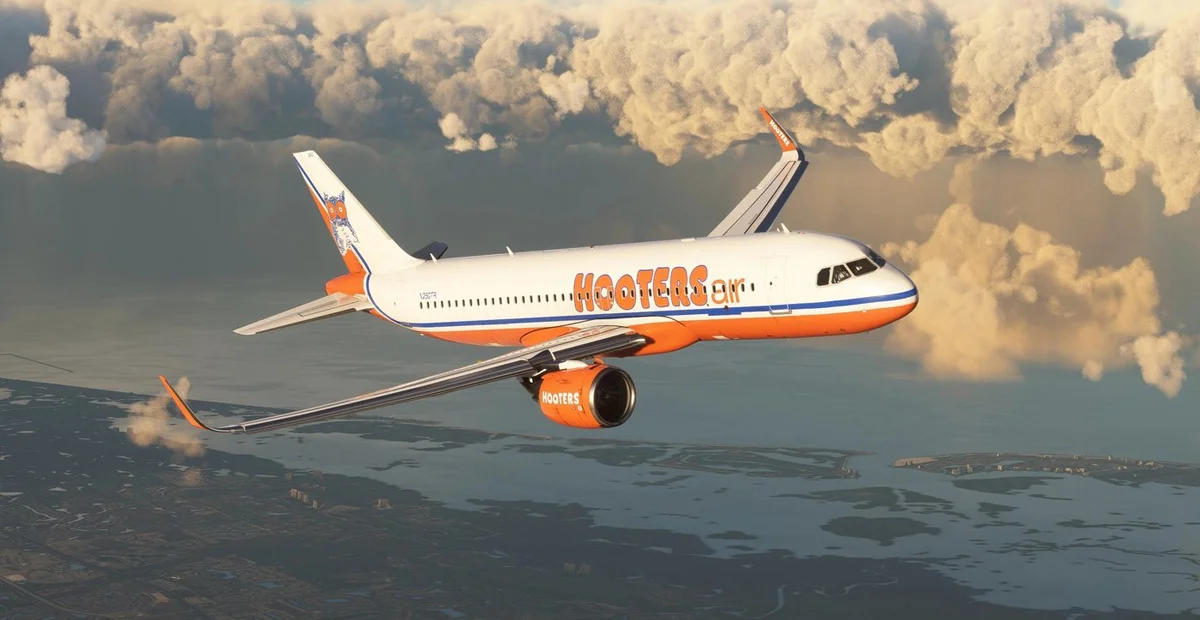 Hooters Air branded jet flying through clouds